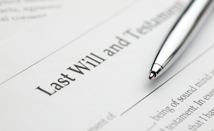 A blank last will and testament form with a pen laying over it.